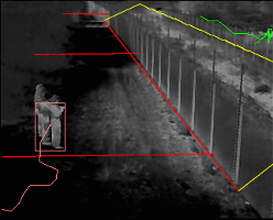 A thermal image of someone standing next to the perimeter fence